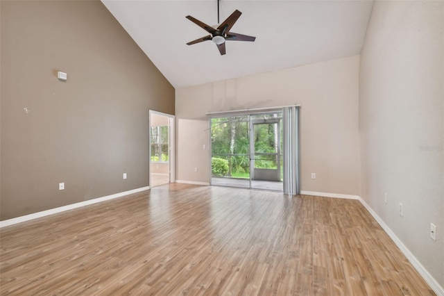 spare room with ceiling fan, high vaulted ceiling, and light wood-type flooring