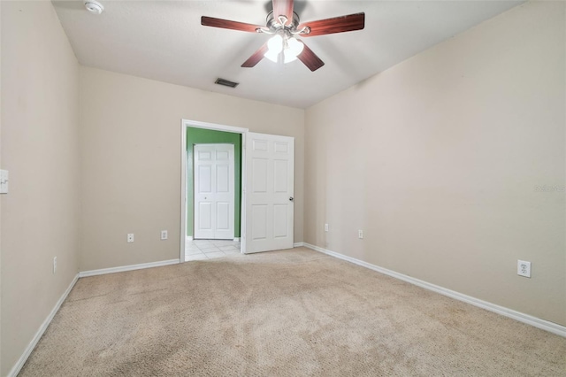 spare room with light colored carpet and ceiling fan