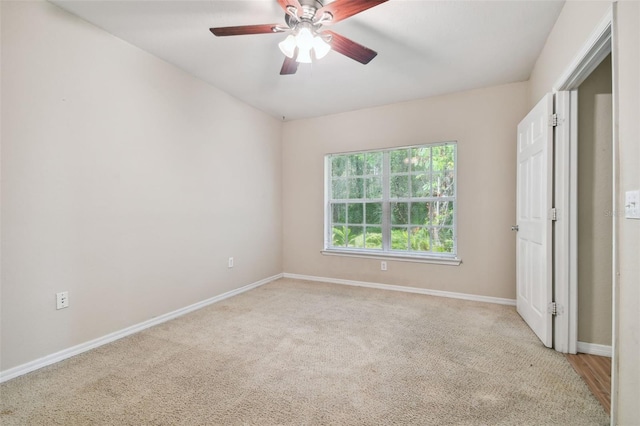 unfurnished bedroom with ceiling fan and light colored carpet