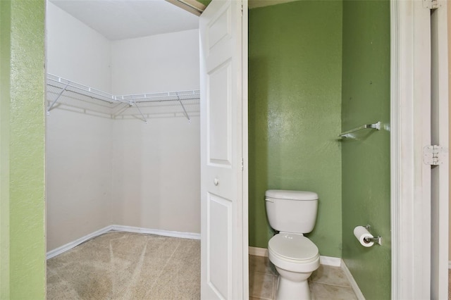 bathroom featuring tile patterned flooring and toilet