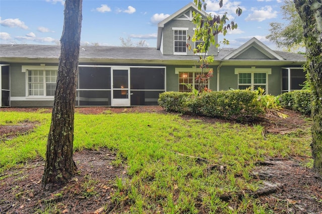 rear view of house featuring a sunroom