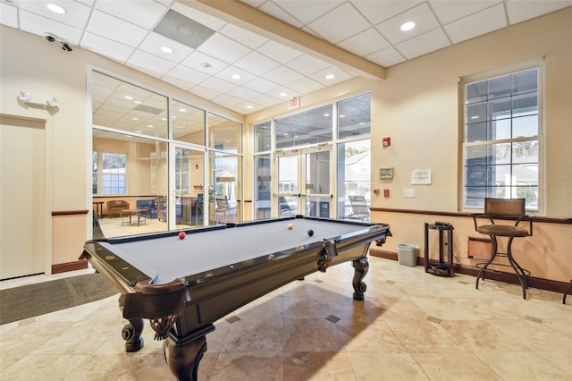 recreation room with a paneled ceiling, light tile patterned flooring, and pool table