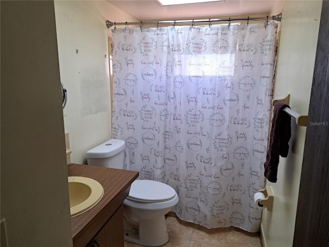 bathroom with tile patterned floors, vanity, toilet, and walk in shower