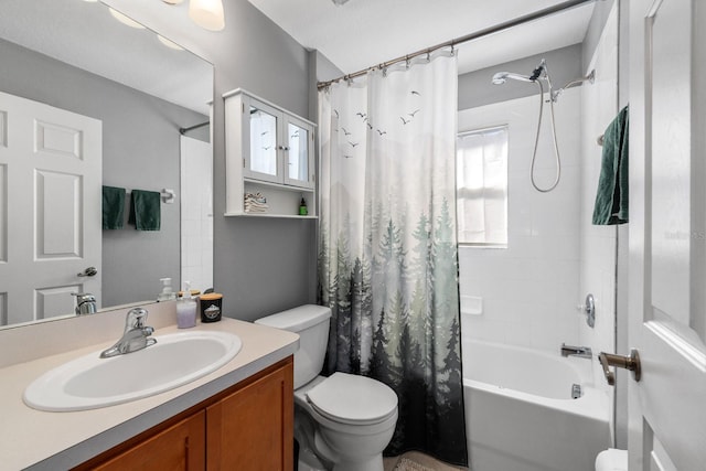 full bathroom with vanity, shower / tub combo, and toilet