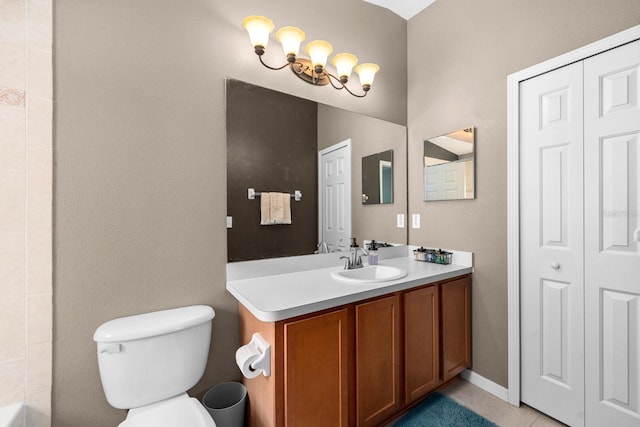 bathroom with tile patterned flooring, vanity, and toilet