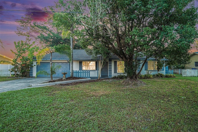 view of front of property with a lawn and a garage