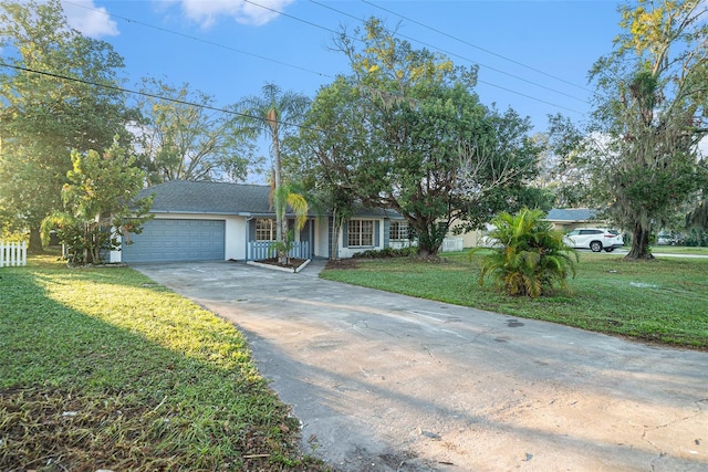 view of front of home with a front yard and a garage