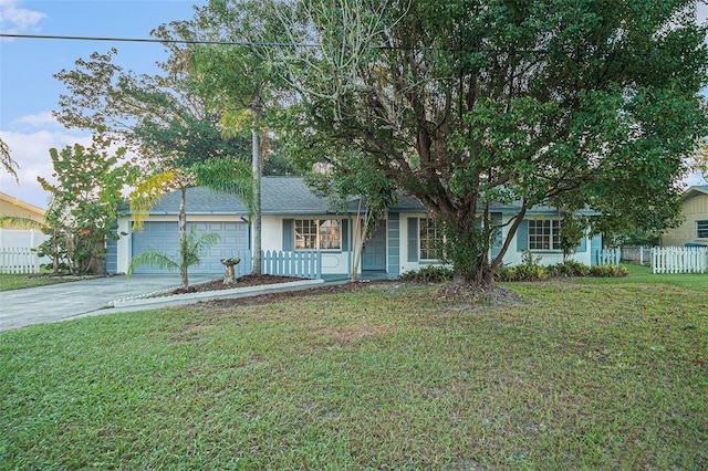 view of front of property featuring a garage and a front lawn