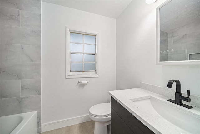 full bathroom featuring tiled shower / bath, vanity, and toilet