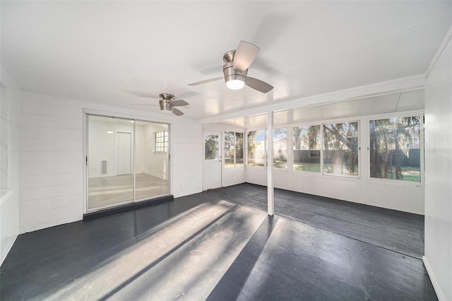 unfurnished sunroom with ceiling fan