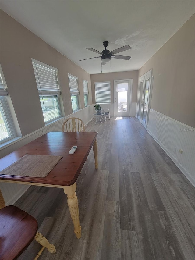 unfurnished dining area featuring dark hardwood / wood-style flooring and ceiling fan