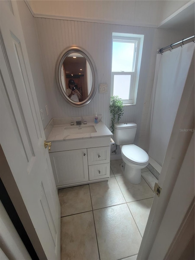 bathroom featuring tile patterned flooring, vanity, toilet, and a shower with shower curtain