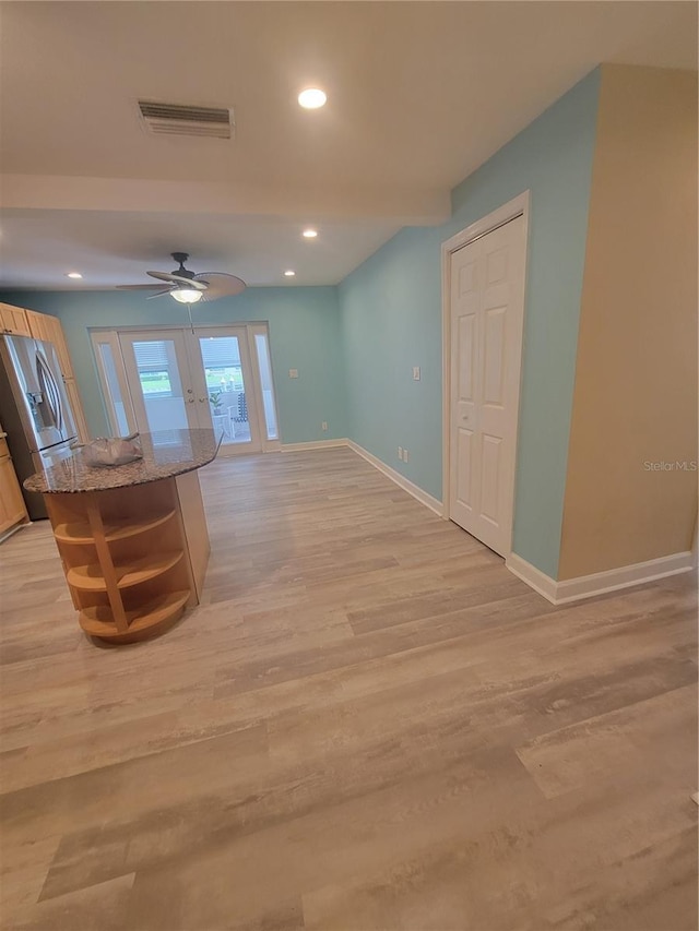 interior space featuring ceiling fan, light hardwood / wood-style floors, and french doors