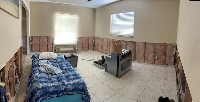 interior space featuring a wood stove and light tile patterned floors