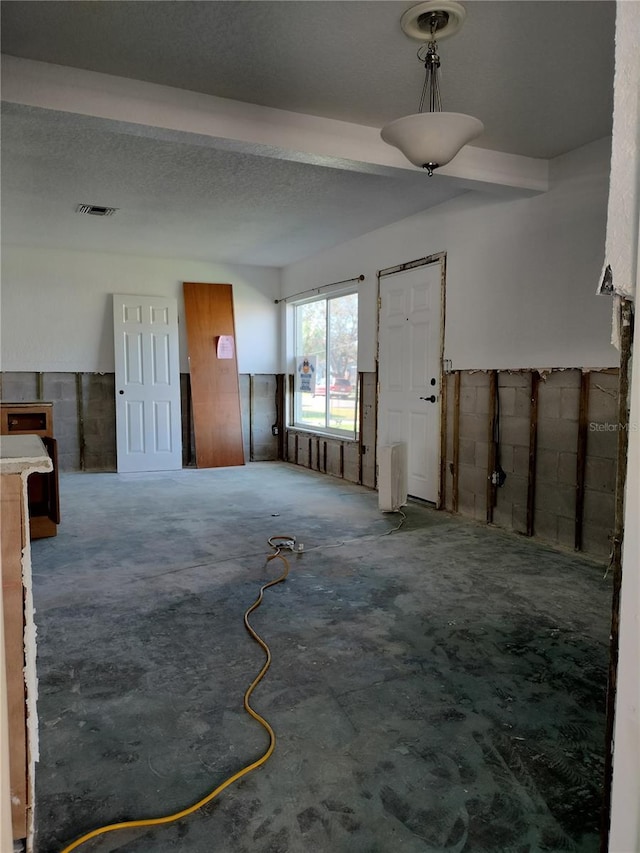 foyer entrance with a textured ceiling