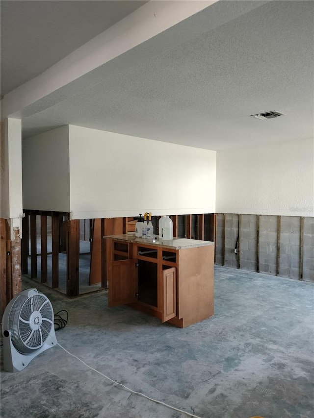 interior space with concrete flooring and a textured ceiling