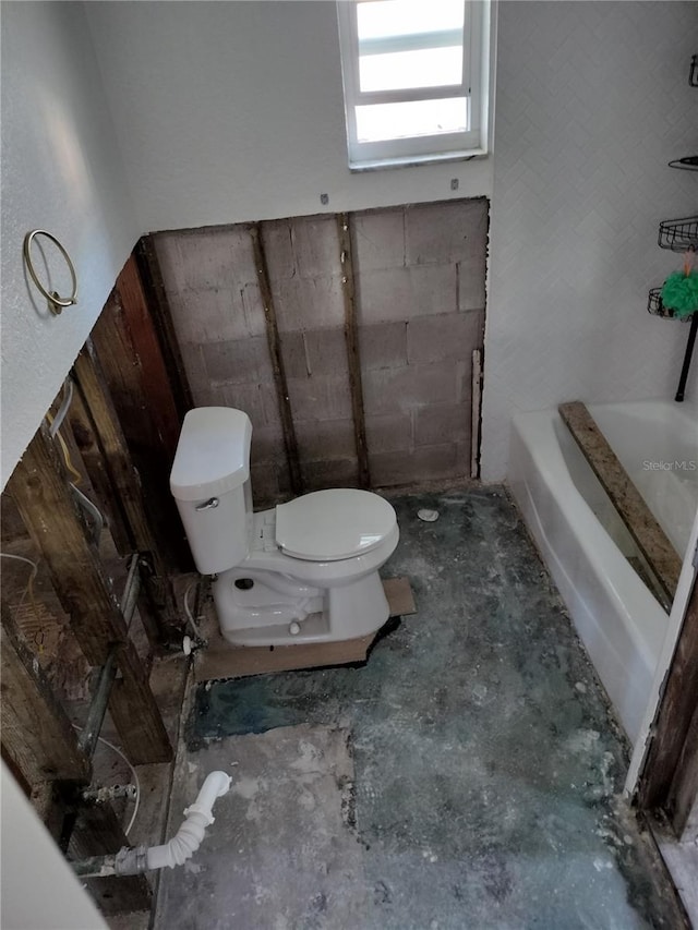 bathroom with toilet and concrete floors