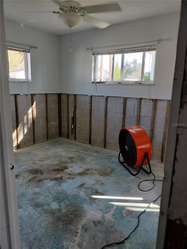 interior space featuring ceiling fan and a healthy amount of sunlight