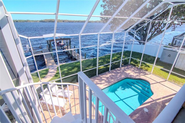 view of swimming pool featuring a patio area and a water view