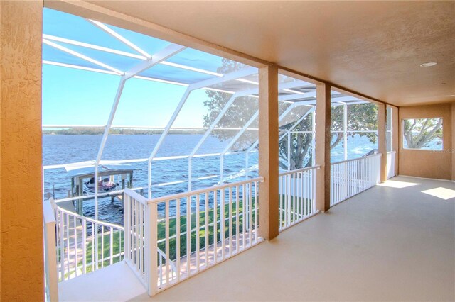 unfurnished sunroom featuring a water view