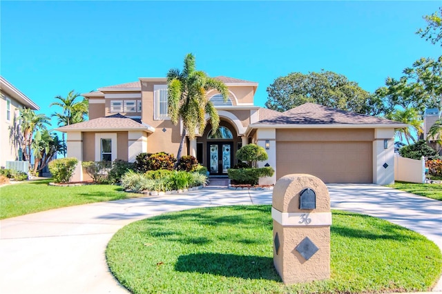 mediterranean / spanish-style house featuring a front yard, french doors, a garage, and central air condition unit