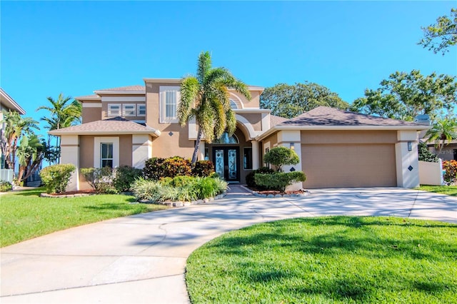 view of front of house featuring french doors, a front yard, and a garage