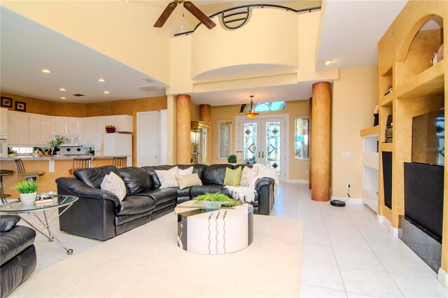 living room with ceiling fan, light tile patterned floors, and french doors