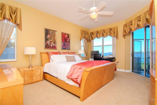 carpeted bedroom with ceiling fan and access to exterior