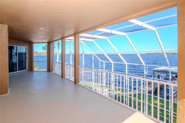 unfurnished sunroom with a healthy amount of sunlight and a water view