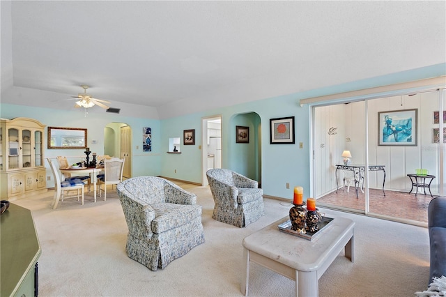 living room featuring light colored carpet and ceiling fan