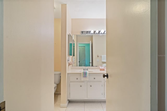 bathroom with tile patterned floors, vanity, and toilet