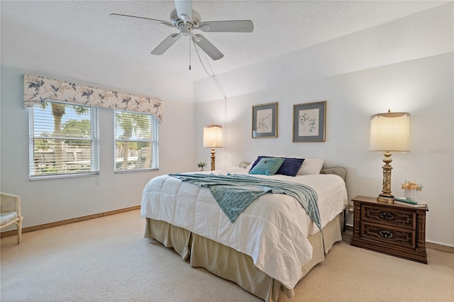 bedroom featuring carpet flooring, ceiling fan, lofted ceiling, and a textured ceiling