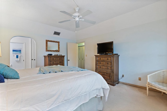 carpeted bedroom featuring ceiling fan, lofted ceiling, and a closet