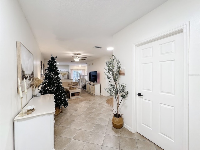 living room featuring ceiling fan and light tile patterned floors