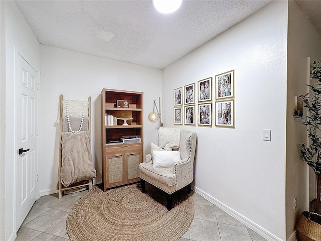 sitting room with light tile patterned floors and a textured ceiling