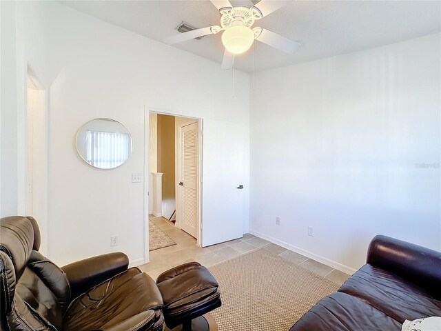 living room featuring ceiling fan and light tile patterned floors