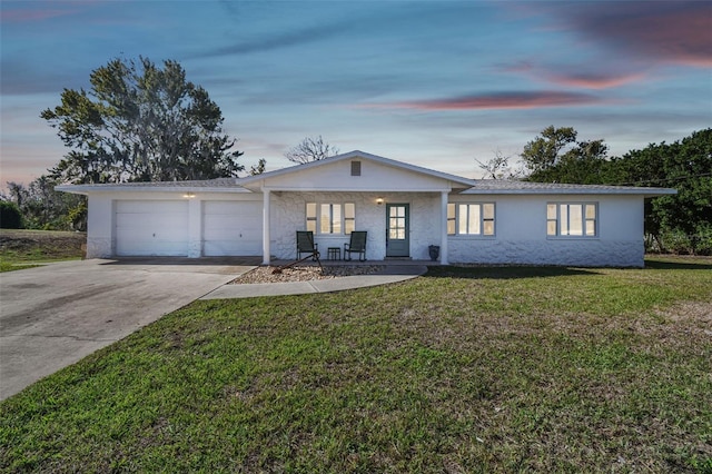 single story home with a yard and a garage