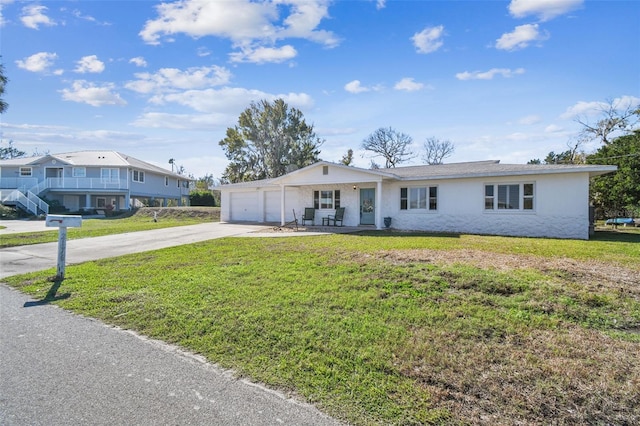 ranch-style home featuring a front lawn and a garage