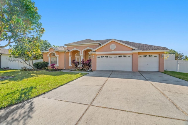 view of front of home featuring a front yard and a garage