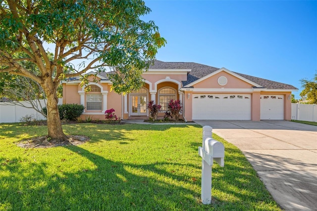 ranch-style home featuring a front yard and a garage