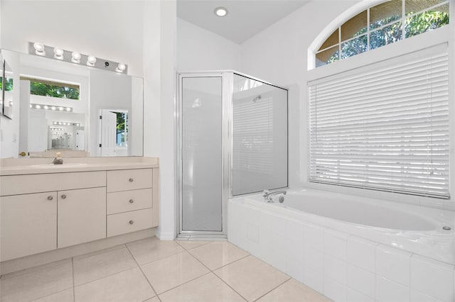 bathroom with tile patterned flooring, vanity, and shower with separate bathtub