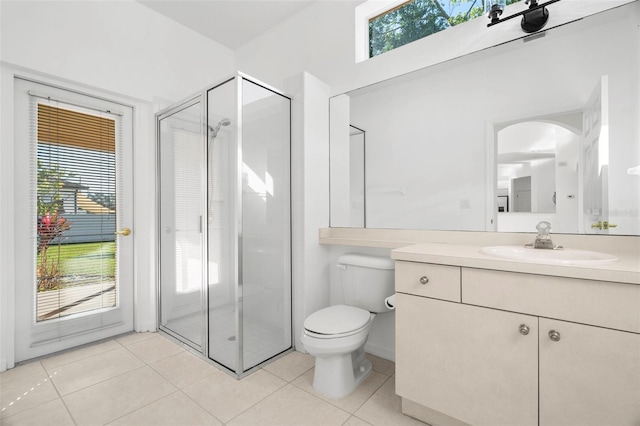 bathroom with tile patterned floors, plenty of natural light, and a shower with shower door