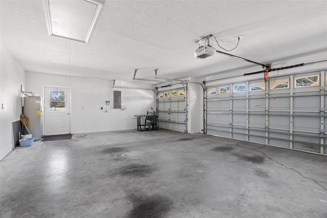 garage featuring electric panel, a garage door opener, and water heater