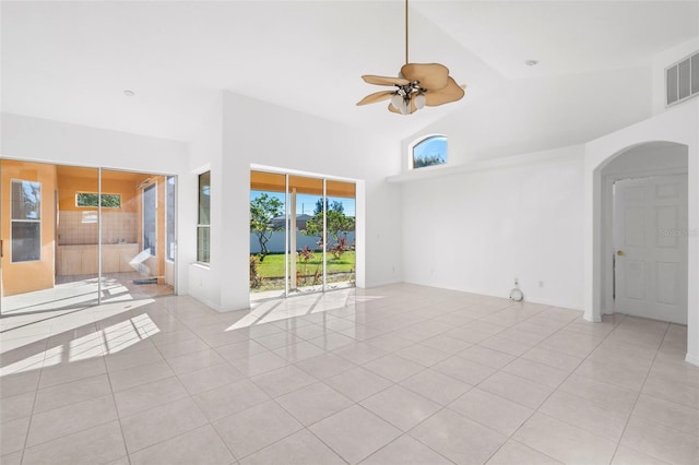 spare room featuring ceiling fan, light tile patterned floors, and high vaulted ceiling