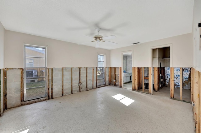 unfurnished room with a wealth of natural light and ceiling fan