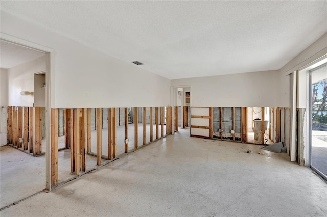 spare room with a textured ceiling