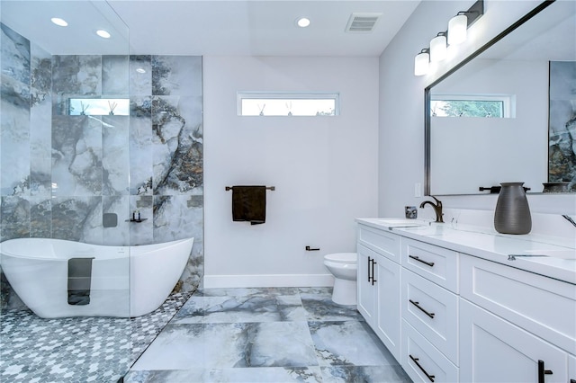 bathroom featuring vanity, a bath, and toilet