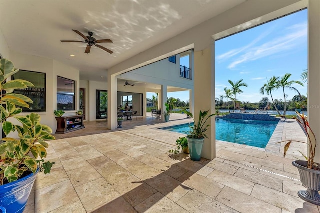 view of pool featuring pool water feature, ceiling fan, and a patio area