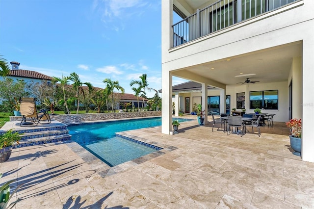 view of pool with a patio and ceiling fan