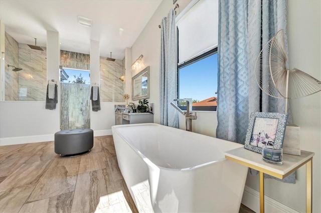 bathroom featuring vanity and independent shower and bath